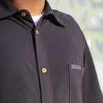 Close up shot of the Blackout shirt by Holystoked, to see the quality of 100% organic cotton stitching.