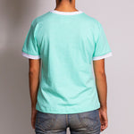 Rear profile shot of the Wild Mint T-shirt by Holystoked, worn by a female skater from Bangalore. 