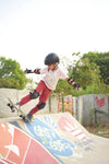 Child learning skateboard trick at The Cave Skatepark, Bangalore.