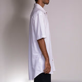 Side view of the White Wine shirt from Holystoked, worn by a skater.